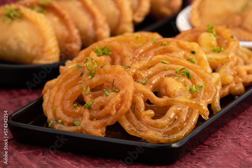 Jalebi Also Called Jilapi, Jilebi, Jilipi, Zulbia, Jerry, Zalebi, Mushabak Is Indian Mithai Made Of Fermented All Purpose Flour Maida, Besan Fried In Desi Ghee Dunked In Sugar Syrup Cheeni Ki Chasni