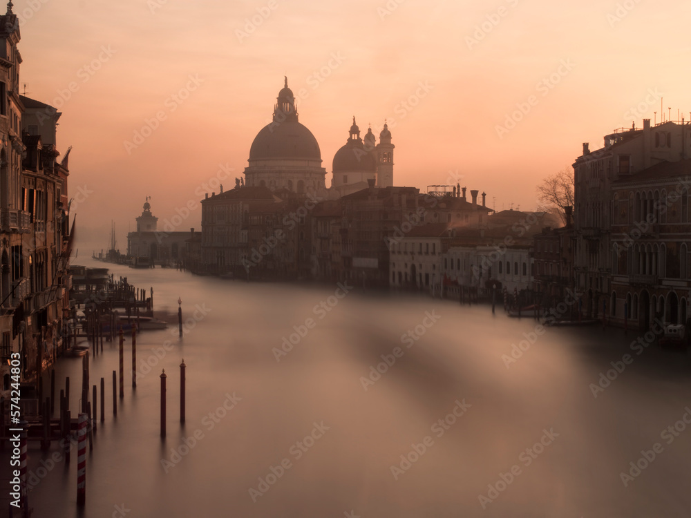 Grand Canal, Venice, Italy. Very early at dawn, fog and mist, no people. Basilica di Santa Maria della Salute in distance.