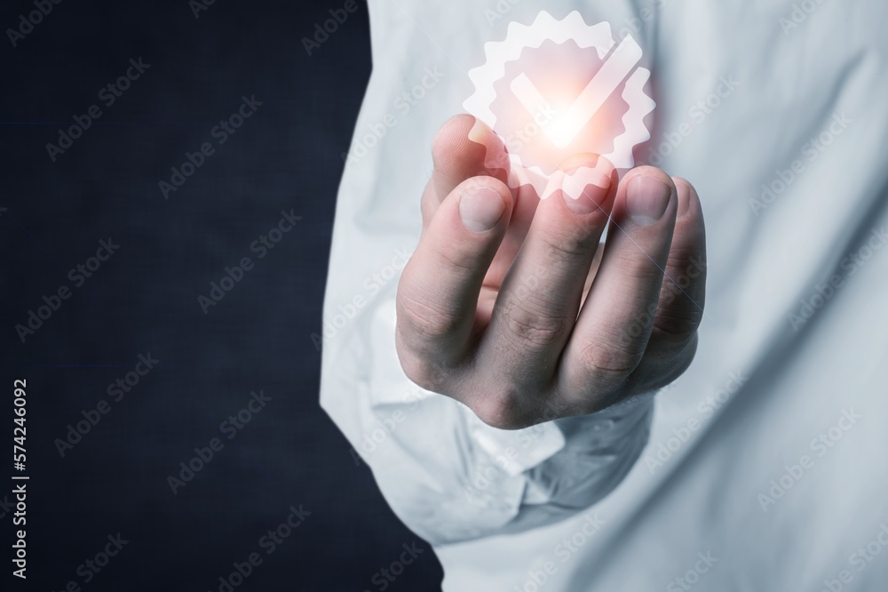 Business man with check mark in hand Business man with check mark in hand