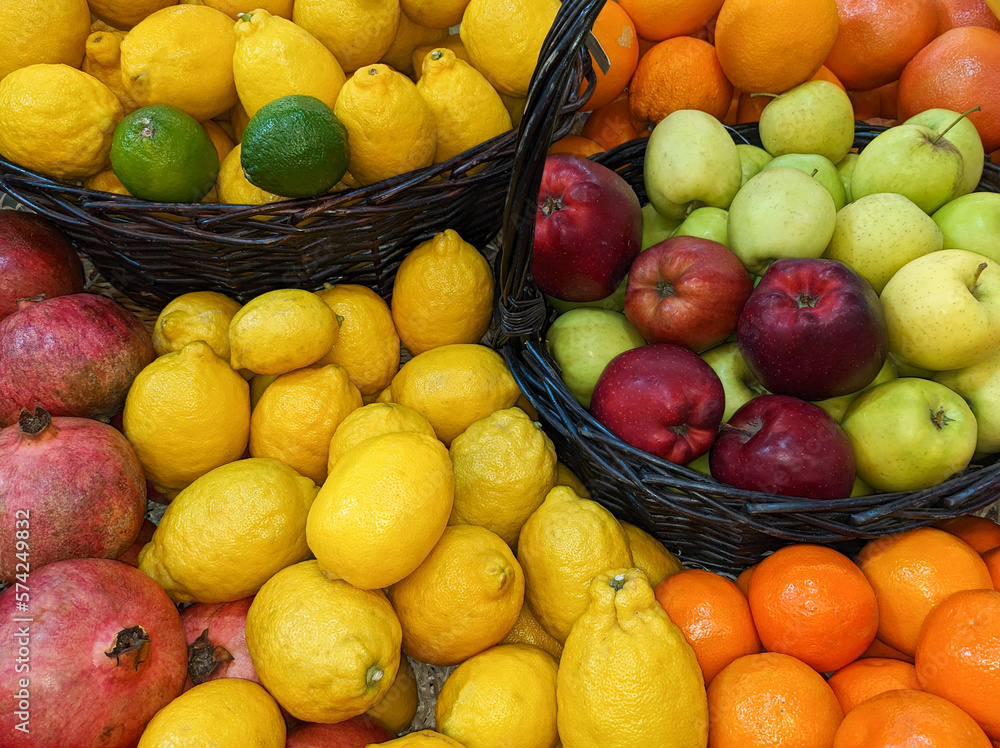 Lots of red and green apples in a basket among lemons and other fruits Lots of red and green apples in a basket among lemons and other fruits