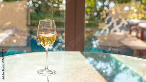 white wine glass. Gold champagne beverage tasting experience on the luxury wooden table for cozy relax in holiday. new year pool romantic dinner drink for self isolation at home resort photo