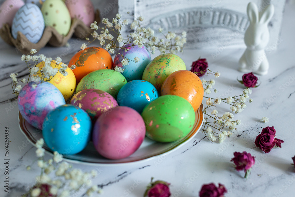 Ideas for decoration for the holiday, food composition. Beautiful multi -colored decorated Easter eggs and a cute white Easter rabbit on a white mromoic background. Close-up Ideas for decoration for the holiday, food composition. Beautiful multi -colored decorated Easter eggs and a cute white Easter rabbit on a white mromoic background. Close-up