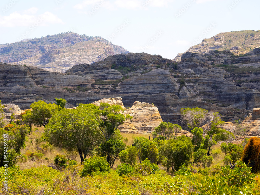 Obraz premium Weathered colorful rocks overgrown with vegetation in N.P Isalo. Madagascar.
