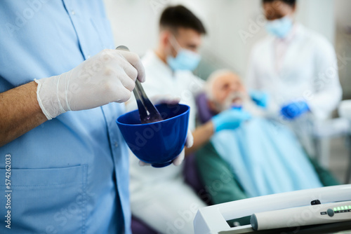 Close up of dental assistant prepares dental mold at dentist's office. photo