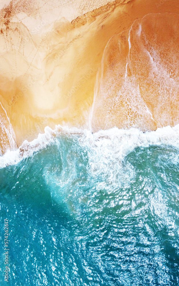 Aerial view of the waves with foam on the sandy ocean shore. Beautiful texture background for tourism and design. Tropical seashore Aerial view of the waves with foam on the sandy ocean shore. Beautiful texture background for tourism and design. Tropical seashore