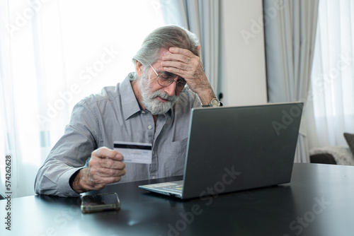 Stressed worried man having problem with paying,Buying online, payments with credit blocked bank card,Internet fraud,Retirement and credit cards.