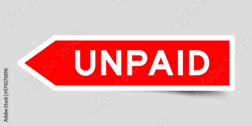 Red color arrow shape sticker label with word unpaid on gray background