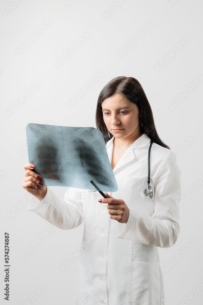 Female doctor examining at lungs radiograph x-ray film of patient, white background Female doctor examining at lungs radiograph x-ray film of patient, white background