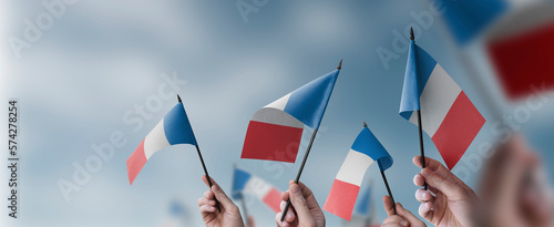 Fotografie A group of people holding small flags of the France in their hands