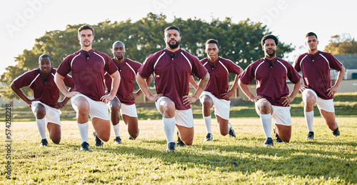 Rugby, sports and a team of men portrait doing lunges for training or competition game on a field. Fitness, sport and stretching with diversity athlete group in a warm up before an outdoor match