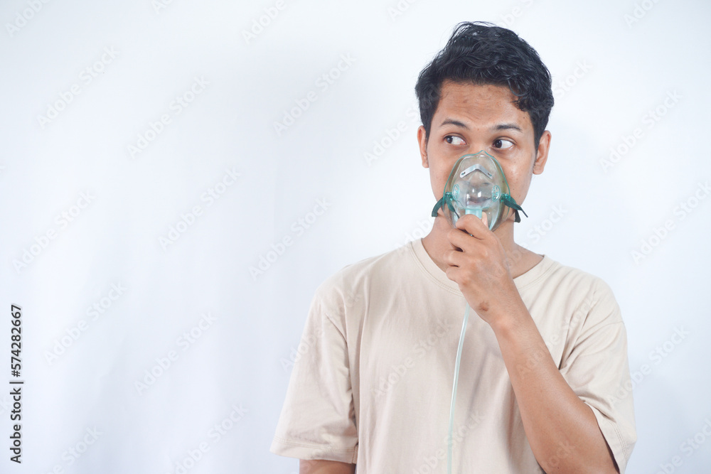 unhealthy young man wearing oxygen mask unhealthy young man wearing oxygen mask