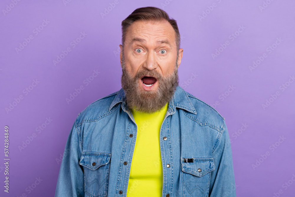 Portrait of impressed speechless aged man open mouth stare isolated on purple color background Portrait of impressed speechless aged man open mouth stare isolated on purple color background