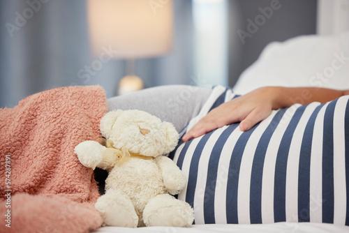 Pregnant stomach, teddy bear and mother in bed with toy for baby, infant and affection at home. Pregnancy love, family and excited, loving and happy woman rest, relaxing and calm in bedroom