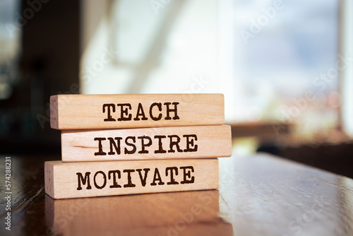 Wooden blocks with words 'Teach Inspire Motivate'.
