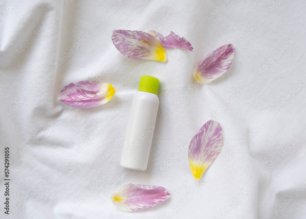 set of cosmetic products with flowers on white background set of cosmetic products with flowers on white background