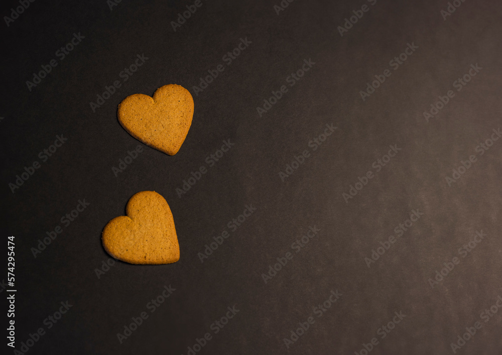 Obraz premium heart shaped cookies on black background, copy space
