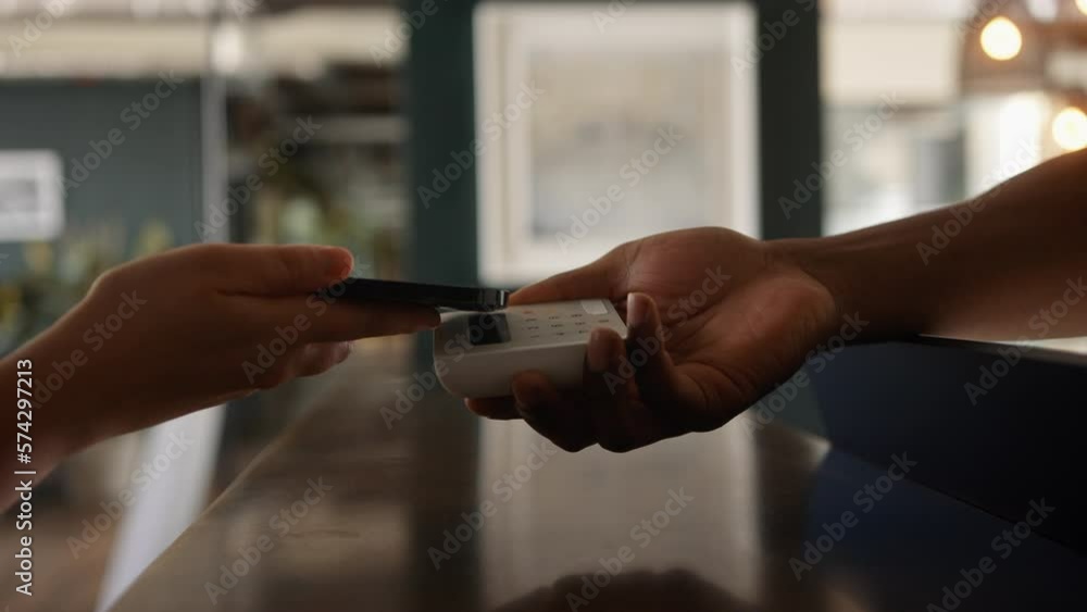 Anonymous Customer Paying with Smart phone on a digital Payment Terminal In a Store Close Up Anonymous Customer Paying with Smart phone on a digital Payment Terminal In a Store Close Up