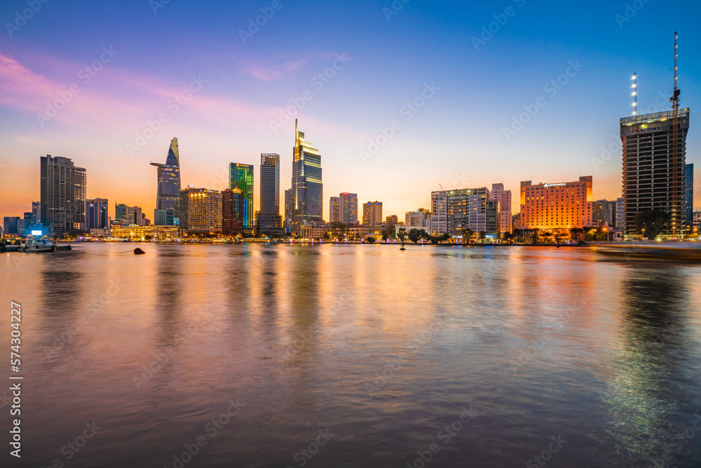 Beautiful Sunset at Bitexco in Ho Chi Minh City, the famous building in Vietnam, with Vietnam flag on the top building. Colorful sky background. Travel concept