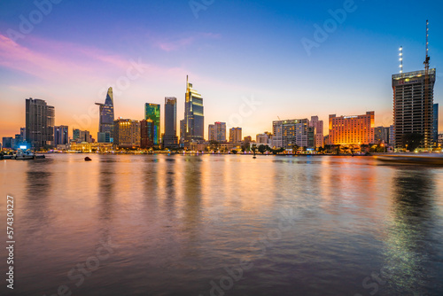 Beautiful Sunset at Bitexco in Ho Chi Minh City, the famous building in Vietnam, with Vietnam flag on the top building. Colorful sky background. Travel concept