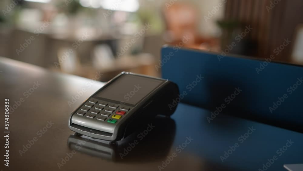 Close In Of Sales Assistant In Retail Shop With Customer Paying Using Contactless Payment Credit Card NFC Close In Of Sales Assistant In Retail Shop With Customer Paying Using Contactless Payment Credit Card NFC