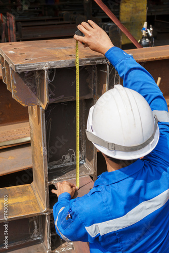 Inspectors use a Measuring Tape to Check the Steel Structures Accuracy after Assembly and Welding before Delivery to Paint.