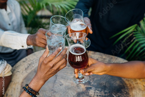 Queer masculine women having a beer in a garden