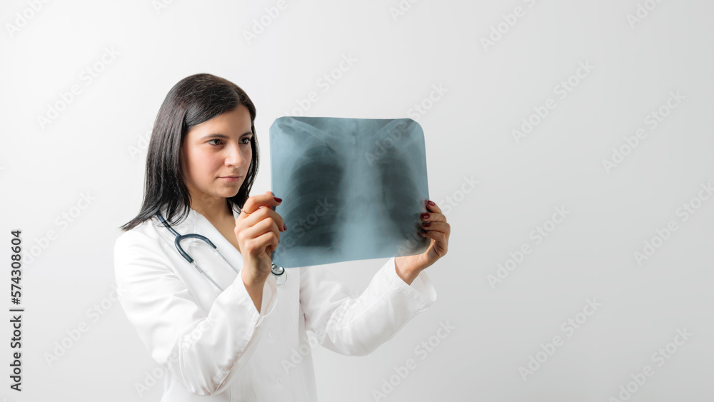 Female doctor examining at lungs radiograph x-ray film of patient, white background Female doctor examining at lungs radiograph x-ray film of patient, white background