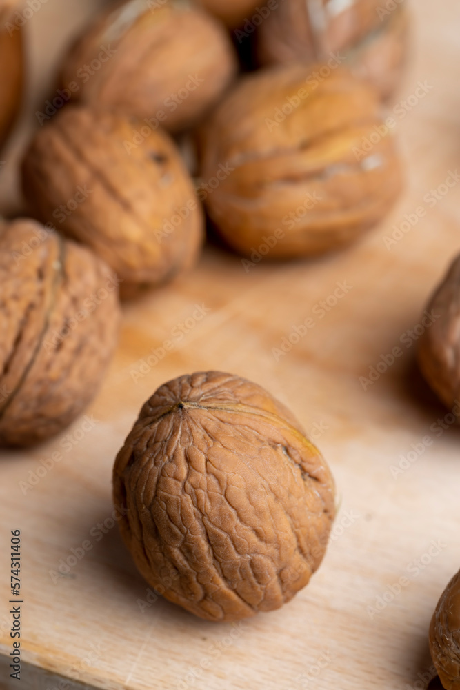 Unpeeled walnut harvest on the table Unpeeled walnut harvest on the table