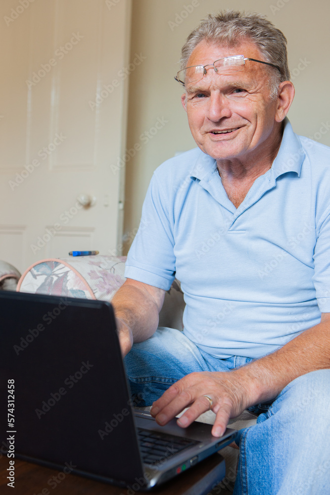 Retirement: Silver Surfer. A senior man on his laptop computer at home. From a series of related images. Retirement: Silver Surfer. A senior man on his laptop computer at home. From a series of related images.