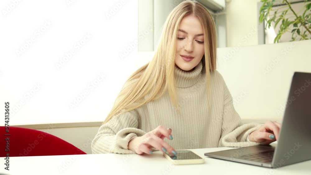 Business woman working on computer and using phone Business woman working on computer and using phone
