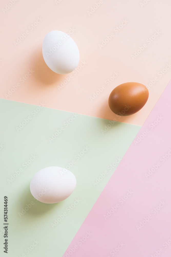 White and brown eggs on multi color background White and brown eggs on multi color background