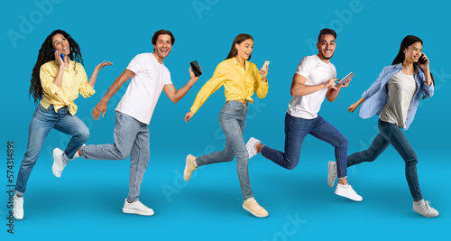 Diverse Happy People Running With Smartphones In Hands Over Blue Background