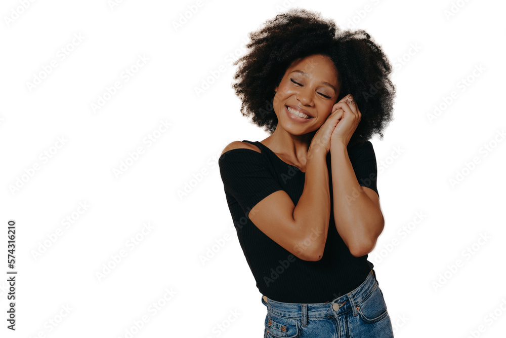 Cute woman keeping hands near face and dreaming of something good, isolated over beige wall Cute woman keeping hands near face and dreaming of something good, isolated over beige wall