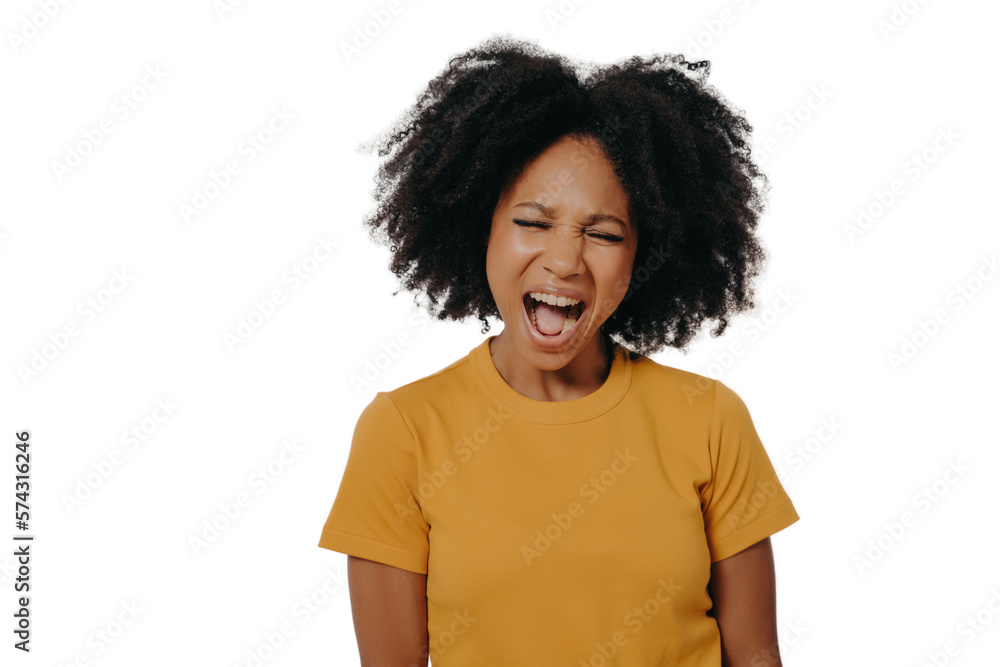 Young beautiful African woman with curly hair wearing casual yellow tshirt shouting with anger
