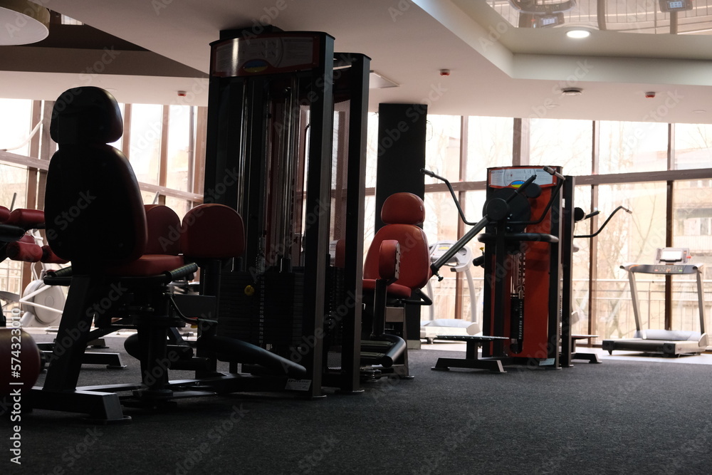 Sports equipment in the gym. Stylish sports space. Expanders and trainers with block weights. Concept: Muscle development and weight gain on simulators, body tone for the summer Sports equipment in the gym. Stylish sports space. Expanders and trainers with block weights. Concept: Muscle development and weight gain on simulators, body tone for the summer