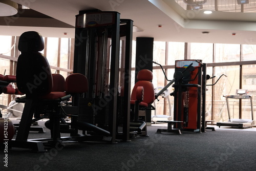 Sports equipment in the gym. Stylish sports space. Expanders and trainers with block weights. Concept: Muscle development and weight gain on simulators, body tone for the summer