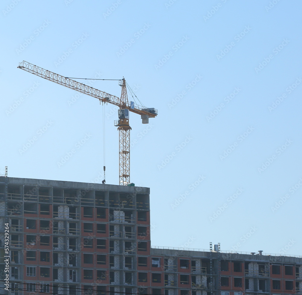 Crane on the construction of an apartment building, Dal'nevostochniy Prospekt, Saint Petersburg, Russia, February 2023 Crane on the construction of an apartment building, Dal'nevostochniy Prospekt, Saint Petersburg, Russia, February 2023