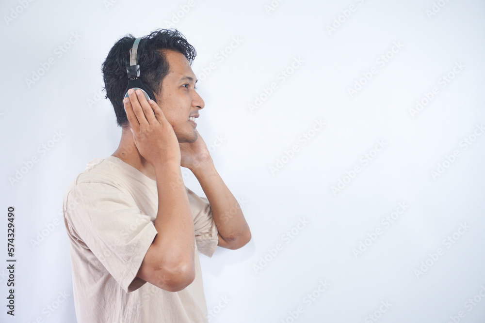 Peaceful positive modern man have black wireless headset listen music enjoy song melody close eyes feel pleasure wear casual style clothes isolated over white color background Peaceful positive modern man have black wireless headset listen music enjoy song melody close eyes feel pleasure wear casual style clothes isolated over white color background