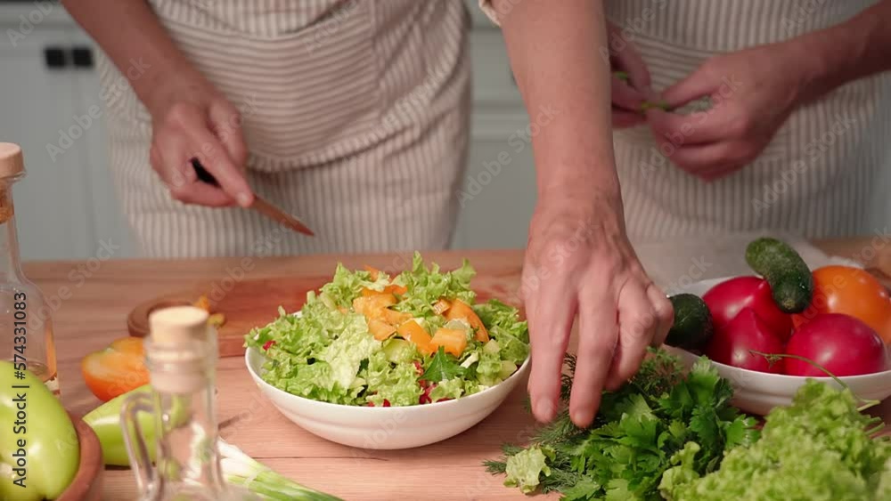 proper nutrition, cute old spouses preparing a fresh vegetable salad for a snack in kitchen, close-up proper nutrition, cute old spouses preparing a fresh vegetable salad for a snack in kitchen, close-up