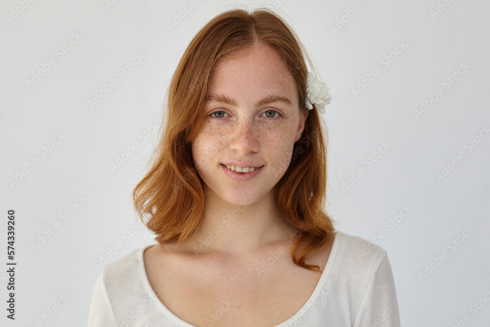 young ginger female looking into camera with broad smile young ginger female looking into camera with broad smile