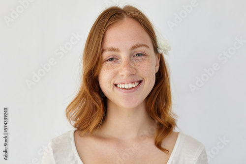 young ginger female looking into camera with broad smile