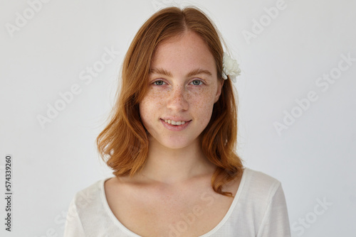 young ginger female looking into camera with broad smile