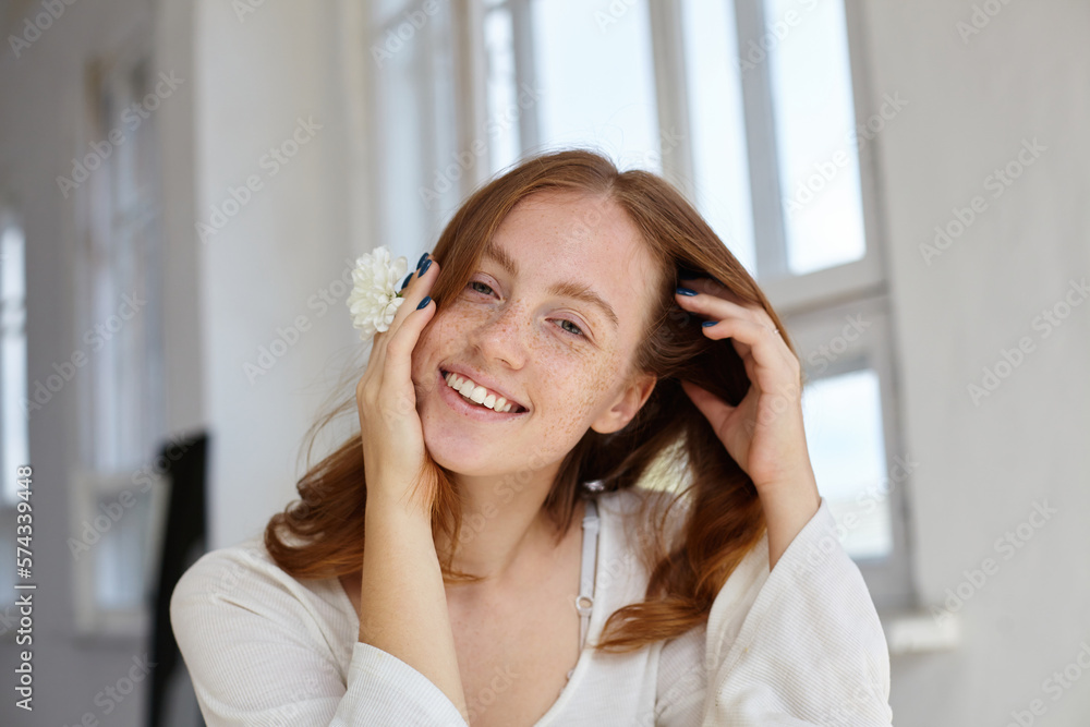 pretty happy young ginger female looking into camera with broad smile pretty happy young ginger female looking into camera with broad smile