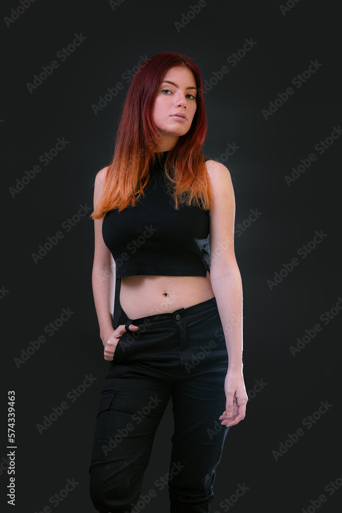 Beautiful young caucasian girl on dark background. Young red hair female fashion model on black background. Fashion photoshoot. Beautiful young caucasian girl on dark background. Young red hair female fashion model on black background. Fashion photoshoot.