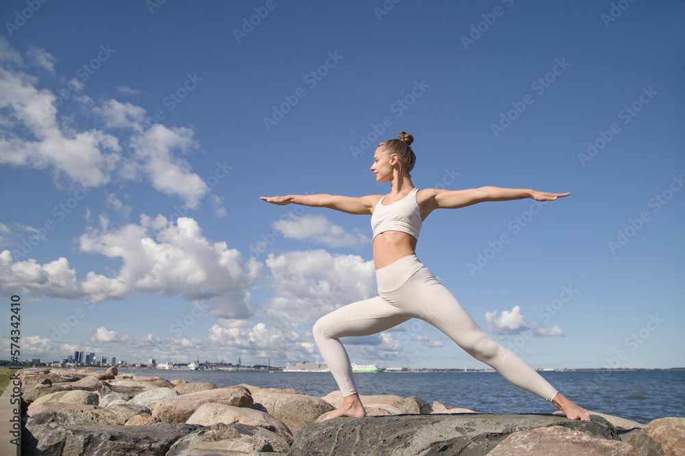 young athletic woman practicing yoga on the beach young athletic woman practicing yoga on the beach
