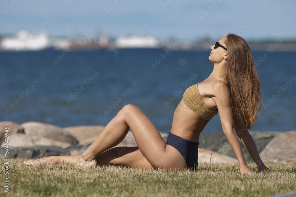 beauty athletic woman in a swimsuit on the beach
