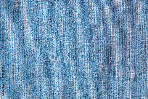 Light blue denim background, detailed fabric texture with high resolution.