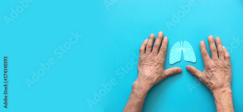 hands old man symbol lungs on blue background, banner, copyspace. healthy lungs, allergies and asthma, lung cancer. ecology clean air