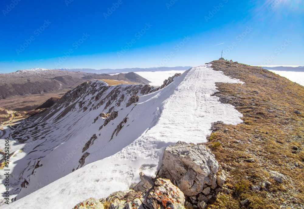 Ovindoli (Abruzzo, Italy) - The Monte della Magnola is a imponent and suggestive mountain peak in Abruzzo region, above the ski resorts of Ovindoli, here during the winter with snow and hiker.