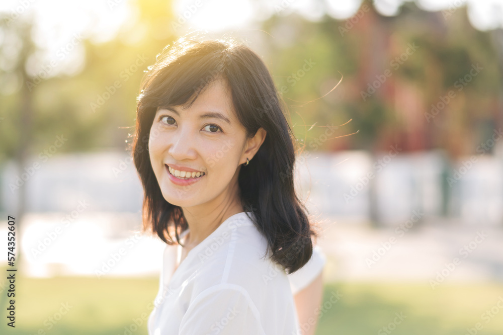 Portrait young beautiful asian woman with happy smile around outdoor park in sunny summer day Portrait young beautiful asian woman with happy smile around outdoor park in sunny summer day